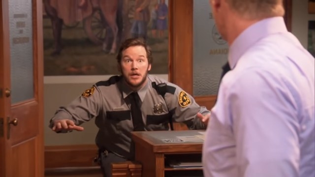 Andy in a police uniform running into the Parks Department in &quot;Parks and Recreation&quot;