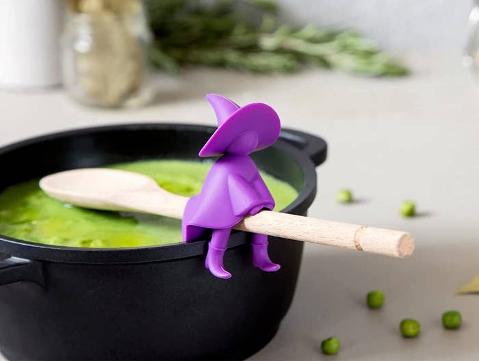witch sits on spoon on pot