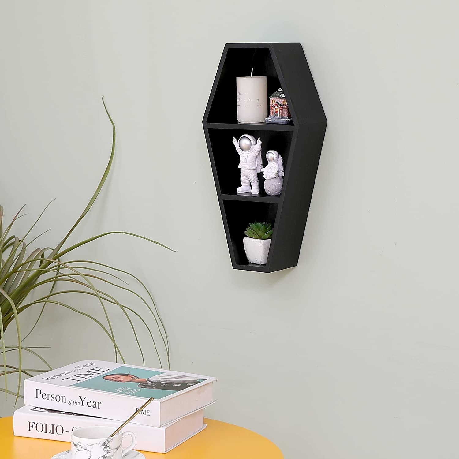 coffin shaped shelf with three levels