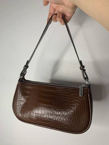 a reviewer holding the purse in brown