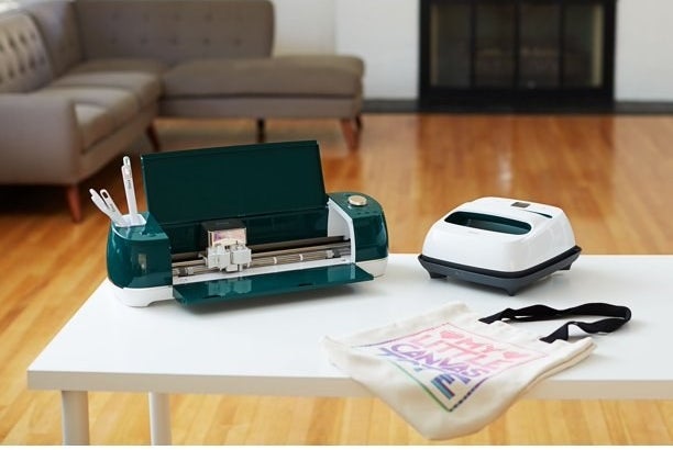 the cutting machine on a table with a canvas tote