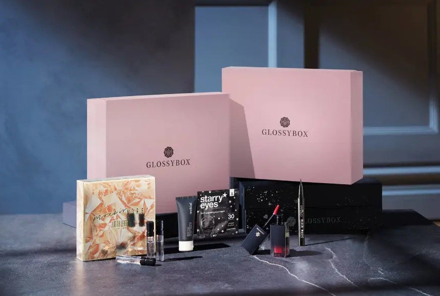 pink Glossybox filled with makeup, perfume, and other beauty goodies