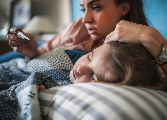 Young mother checking her child's temperature
