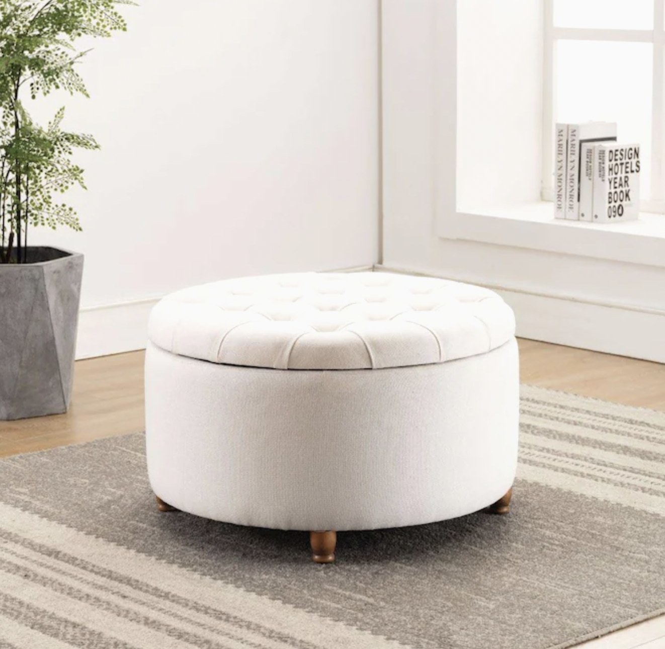 Cream colored 28-inch circular storage ottoman on the floor