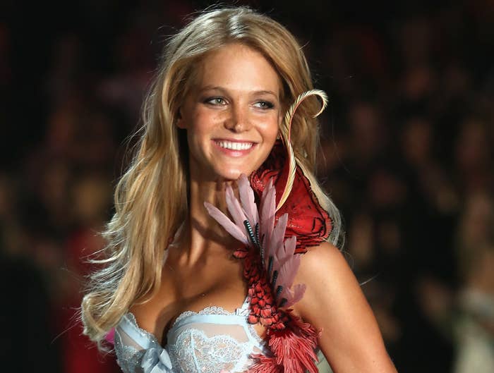 Erin smiles while walking in a Victoria&#x27;s Secret show