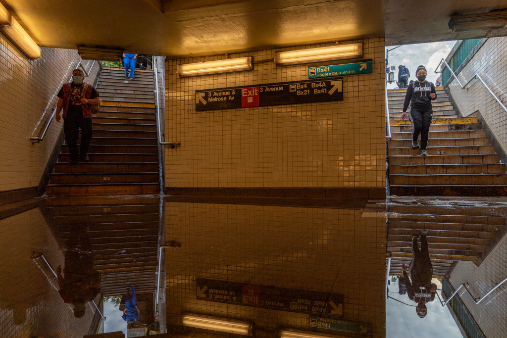 Commuters walk into a flooded 3rd Avenue / 149th st subway station and disrupted service due to extremely heavy rainfall from the remnants of Hurricane Ida