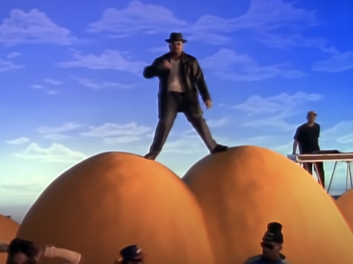 Sir Mix-a-Lot standing atop a giant butt in the video