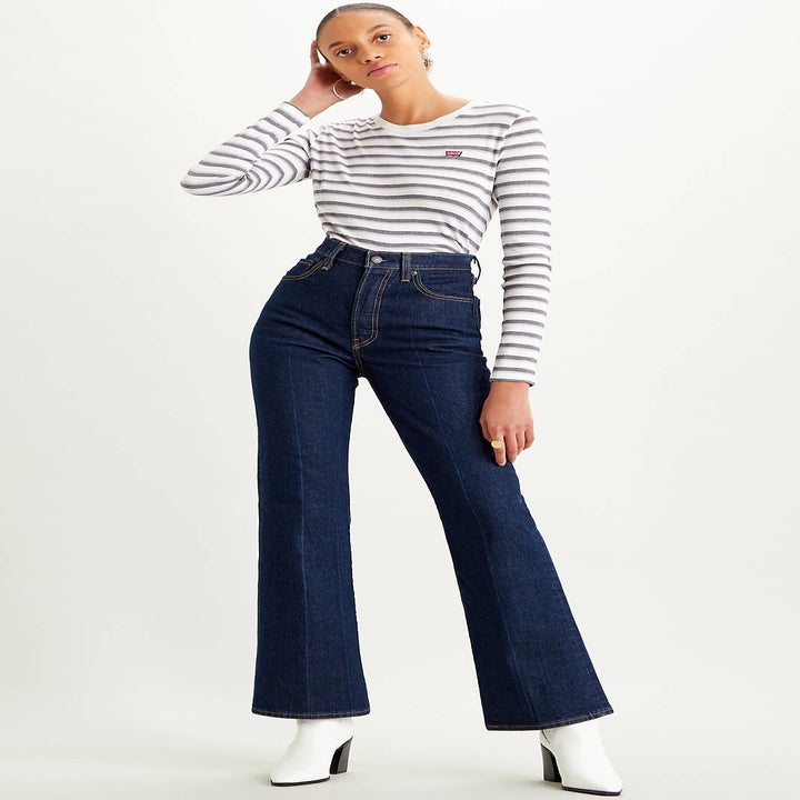 A model wearing the medium wash bootcut jeans