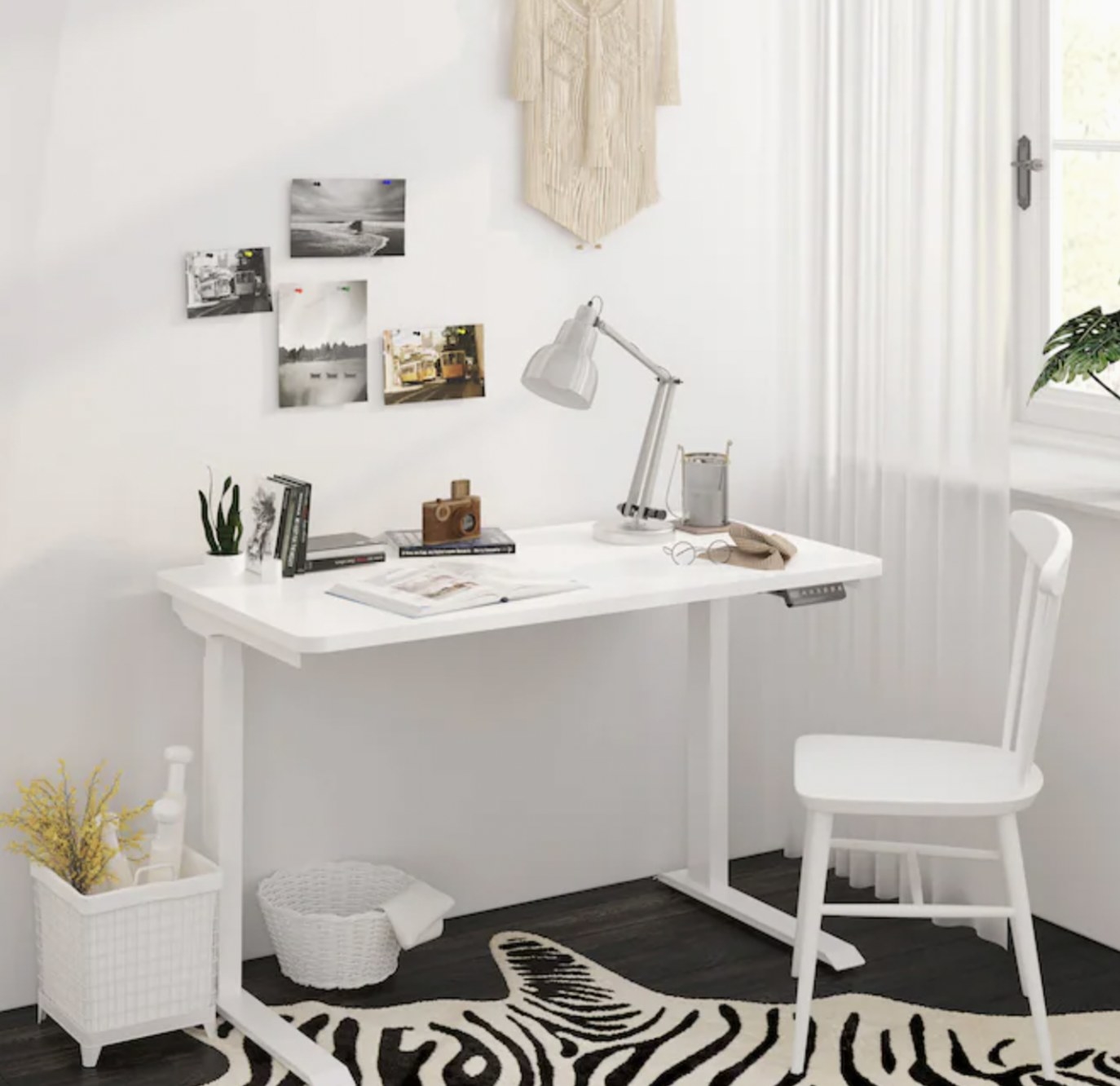 White standing desk with control panel against a wall in a room
