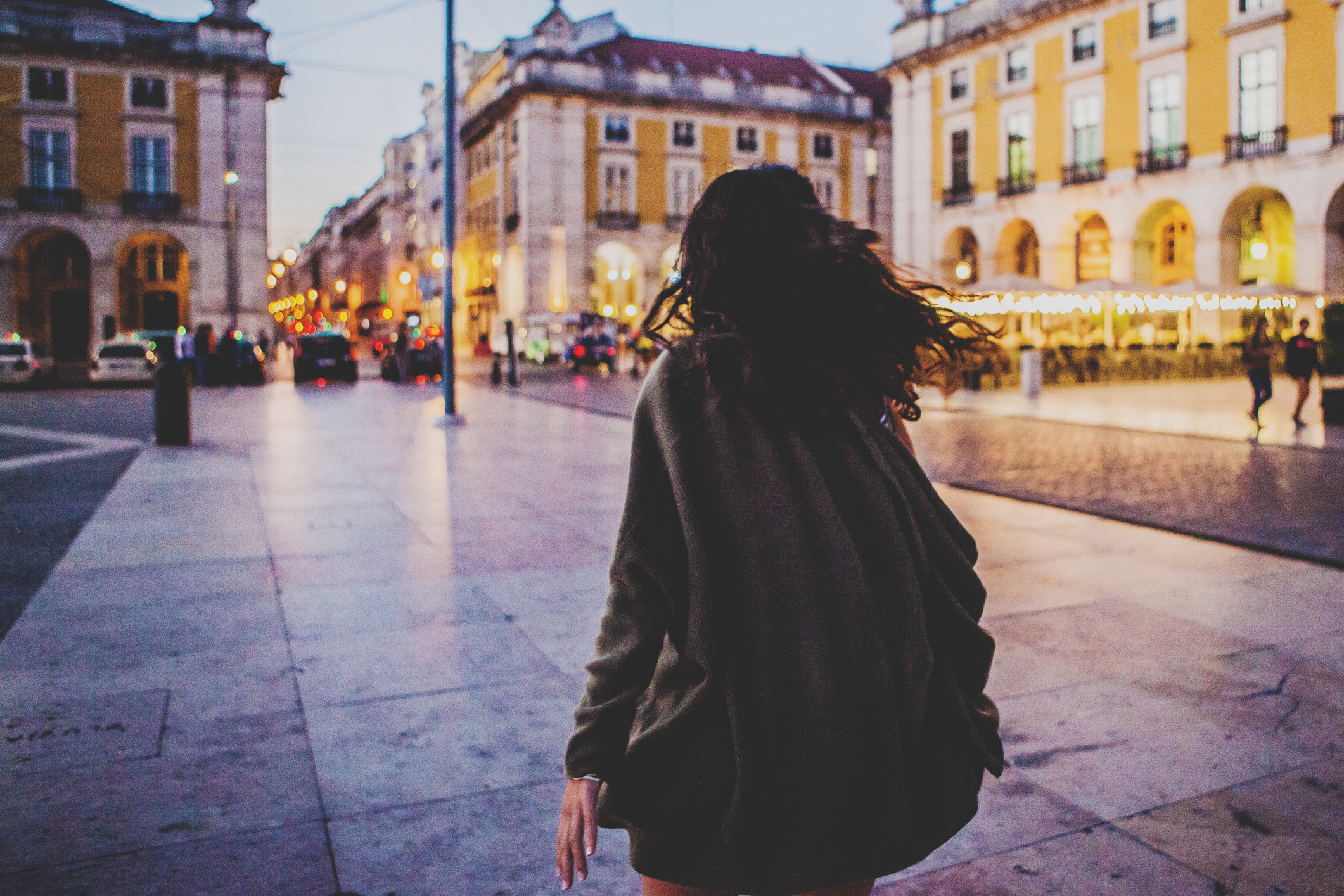 A woman walking alone in Lisbon.