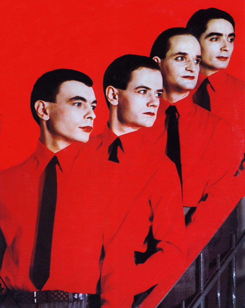Kraftwerk posing in their matching red shirts and black ties