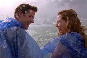 Jim and Pam from The Office smiling at each other as mist from Niagara Falls hits them 