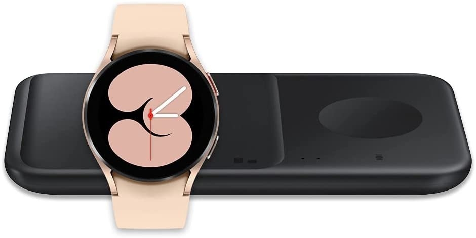 the rose gold watch with a black charging dock