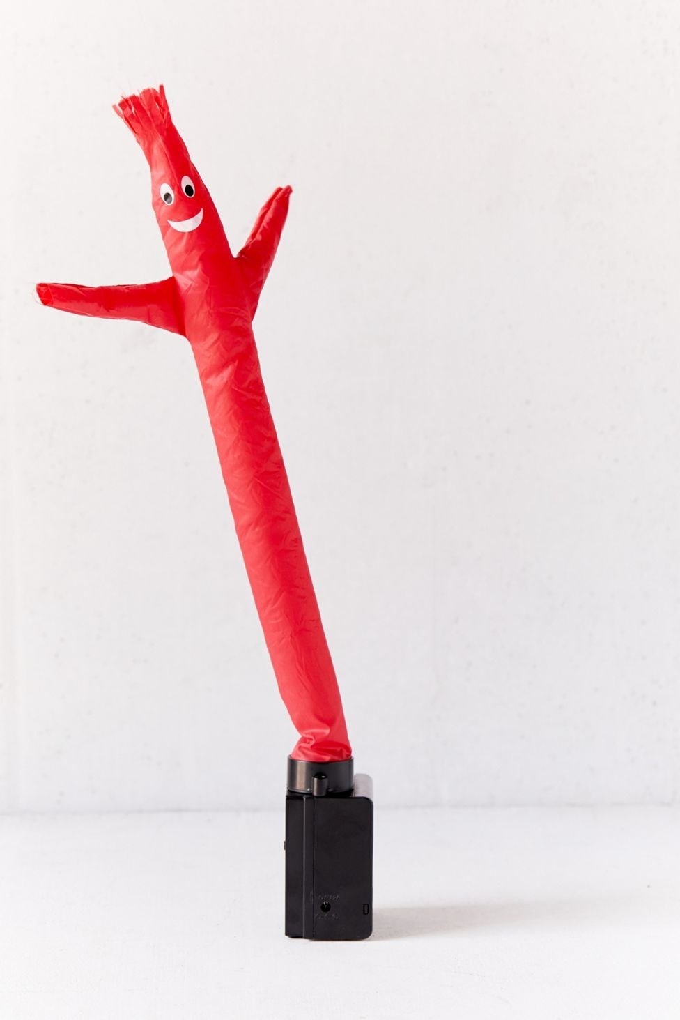 red tube guy on a black stand