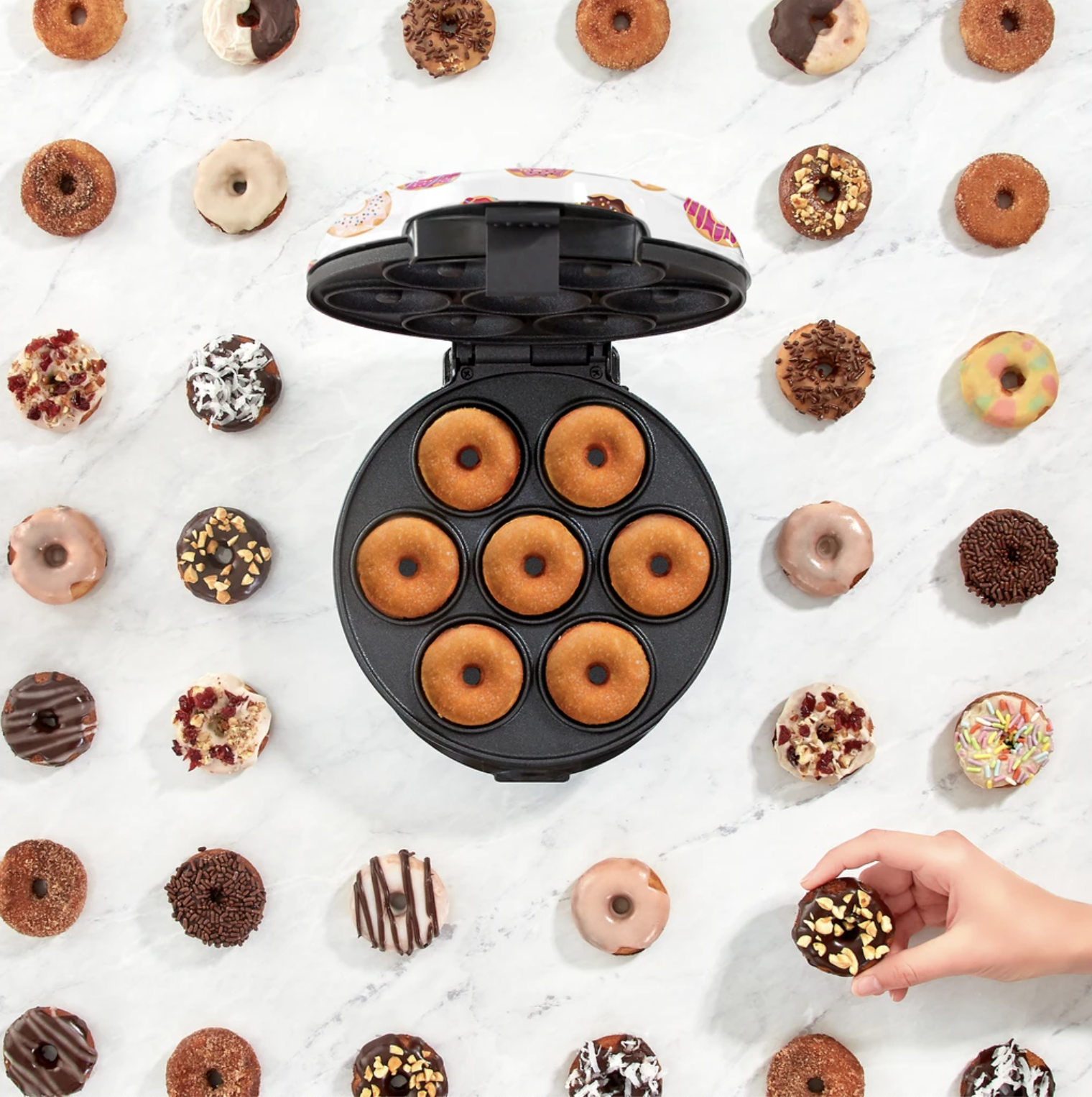 The machine surrounded by different types of donuts