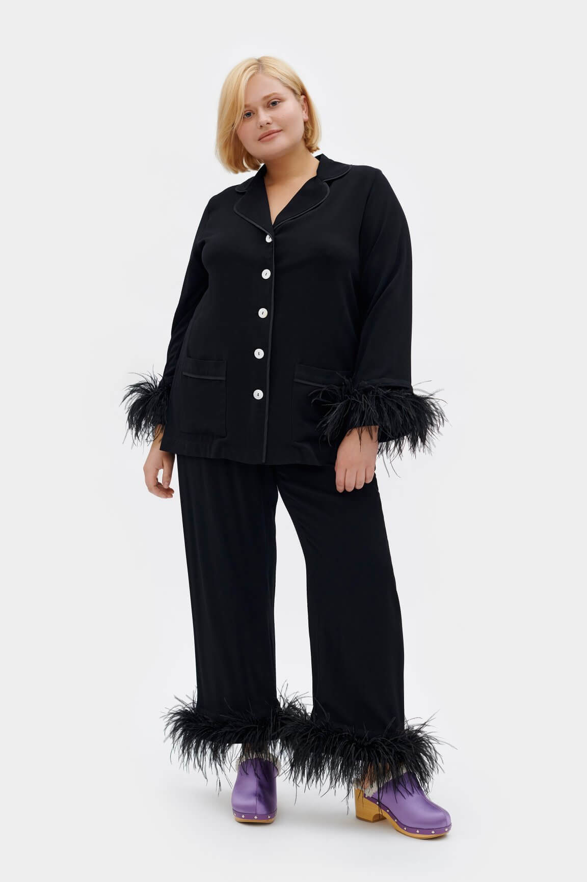 model in long sleeve and pants pajama set with feather boa accent on the wrists and ankles