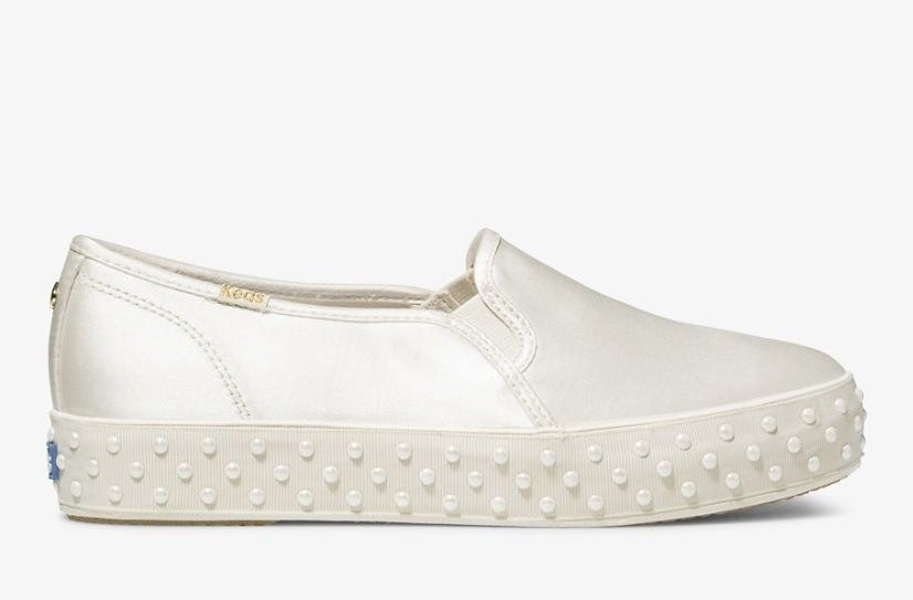 A shoe with a thick sole and pearls around the edge