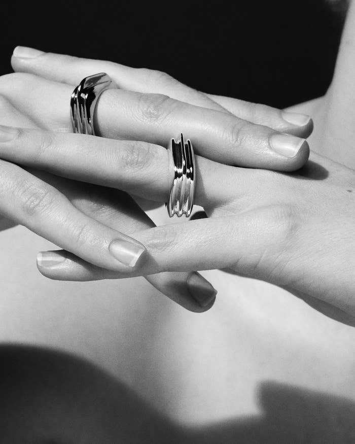 A person wearing two rings on their fingers