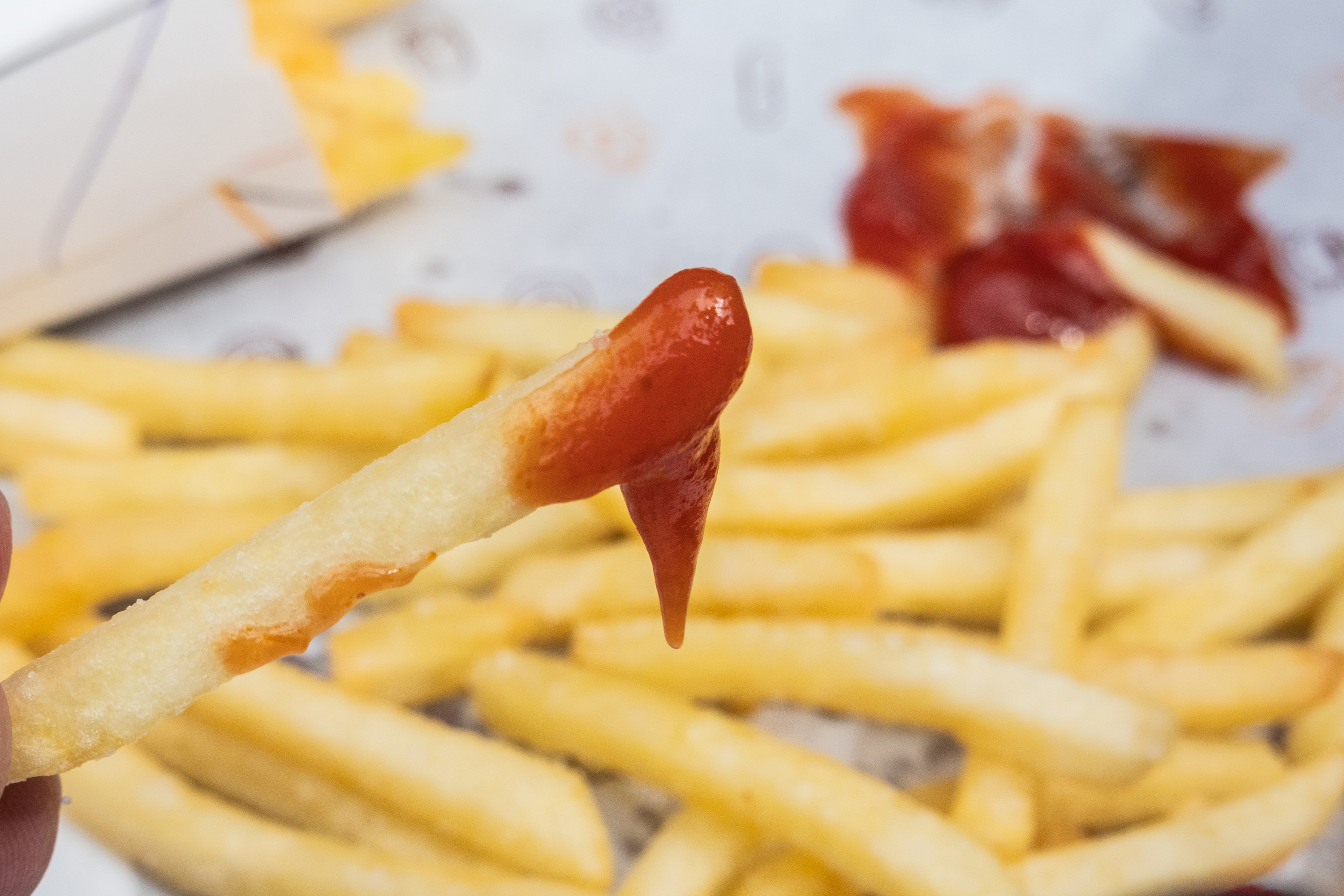 french fry dipped in ketchup