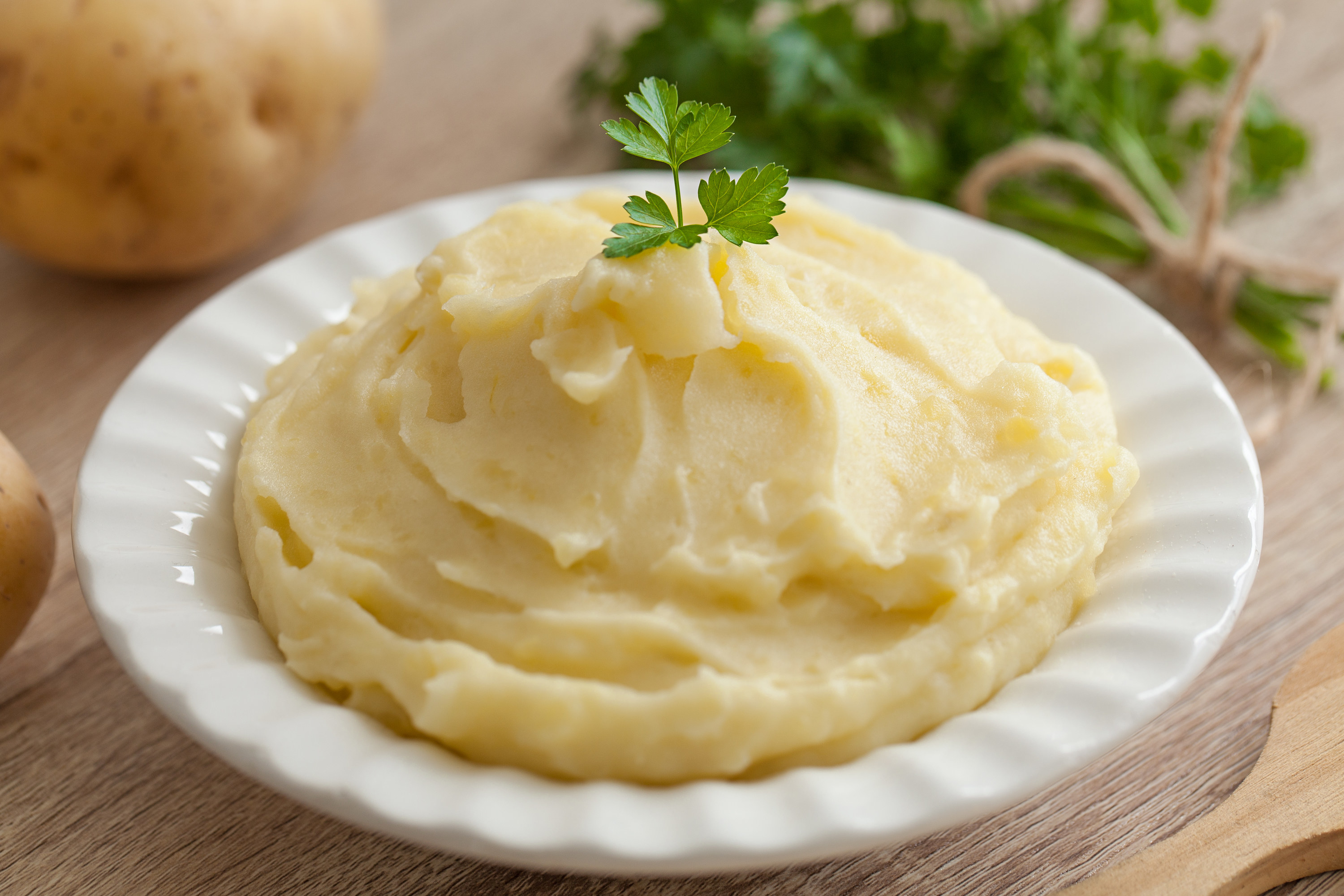 mashed potatoes neatly served in a dish with parsley on top