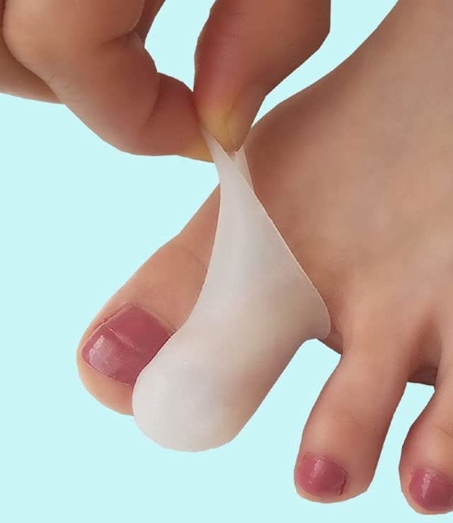 a person slipping the silicone sleeve over one of their toes