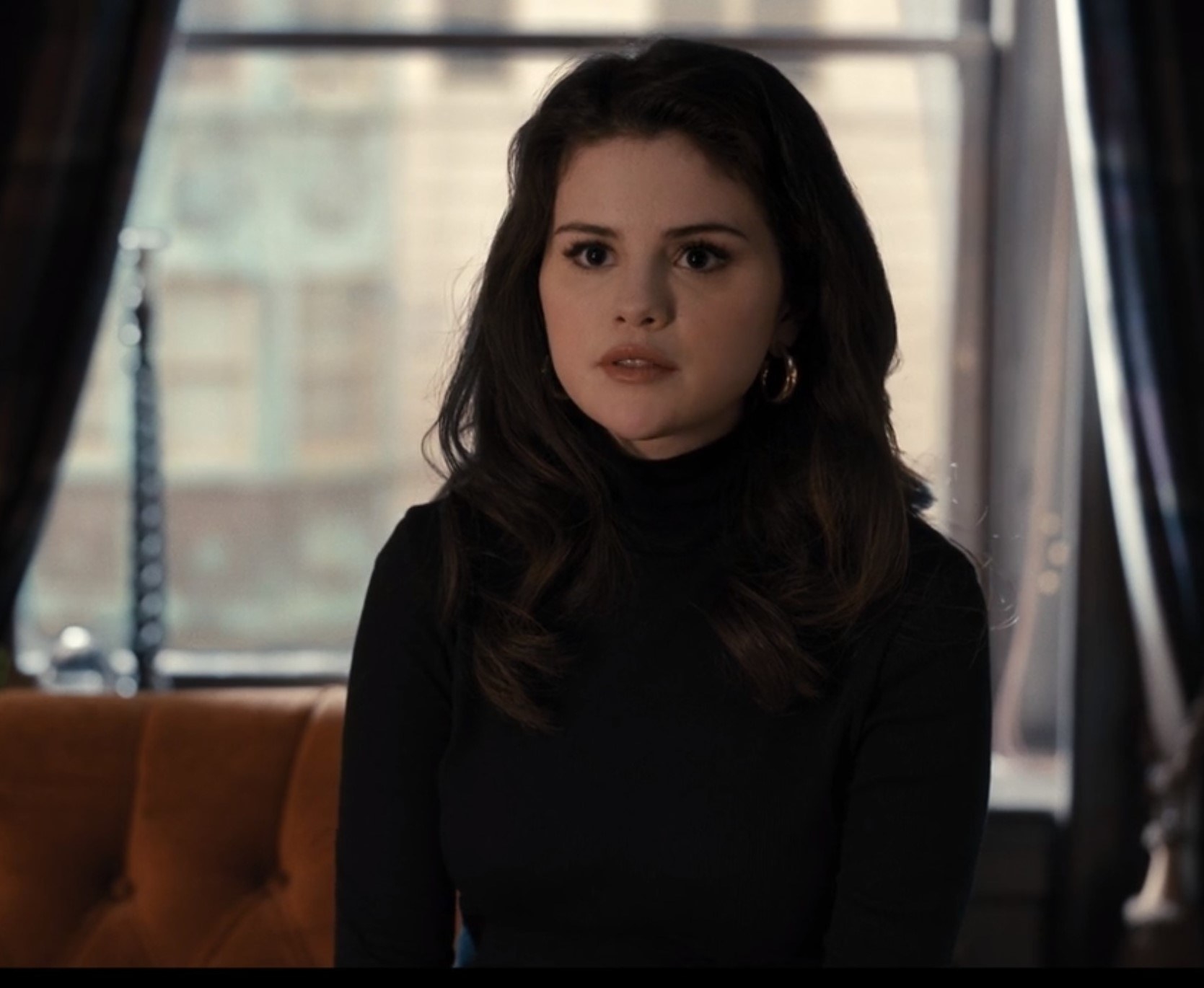 Photo of Selena Gomez as Mabel in a black turtleneck