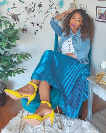 reviewer wearing the blue metallic skirt