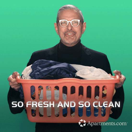 A man holding a basket full of clean clothes.