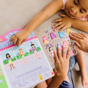 Children playing with the princess sticker activity book
