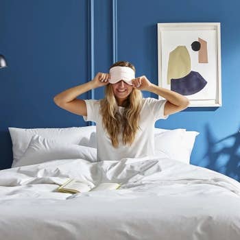 Model wearing the eye mask in bed