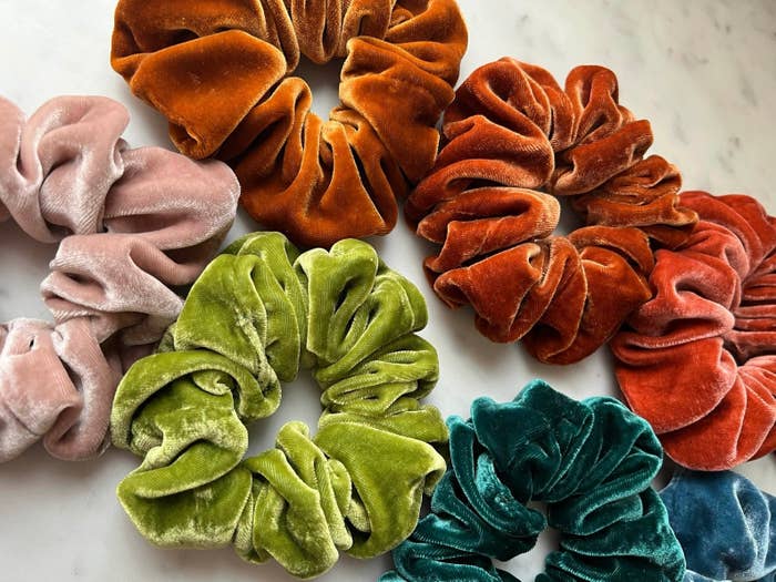 An assortment of velvet scrunchies in different colors