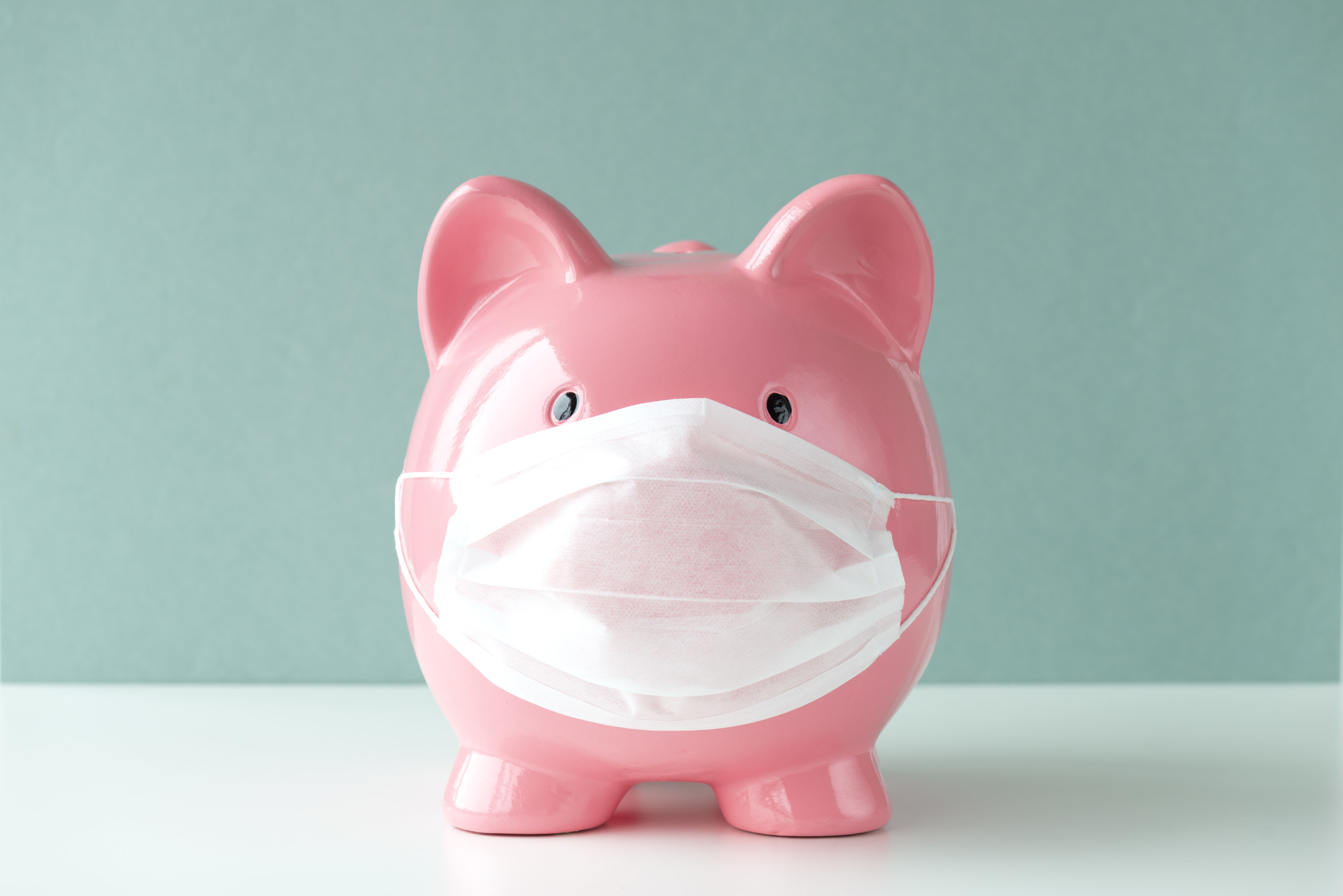 A piggy bank with a face mask on