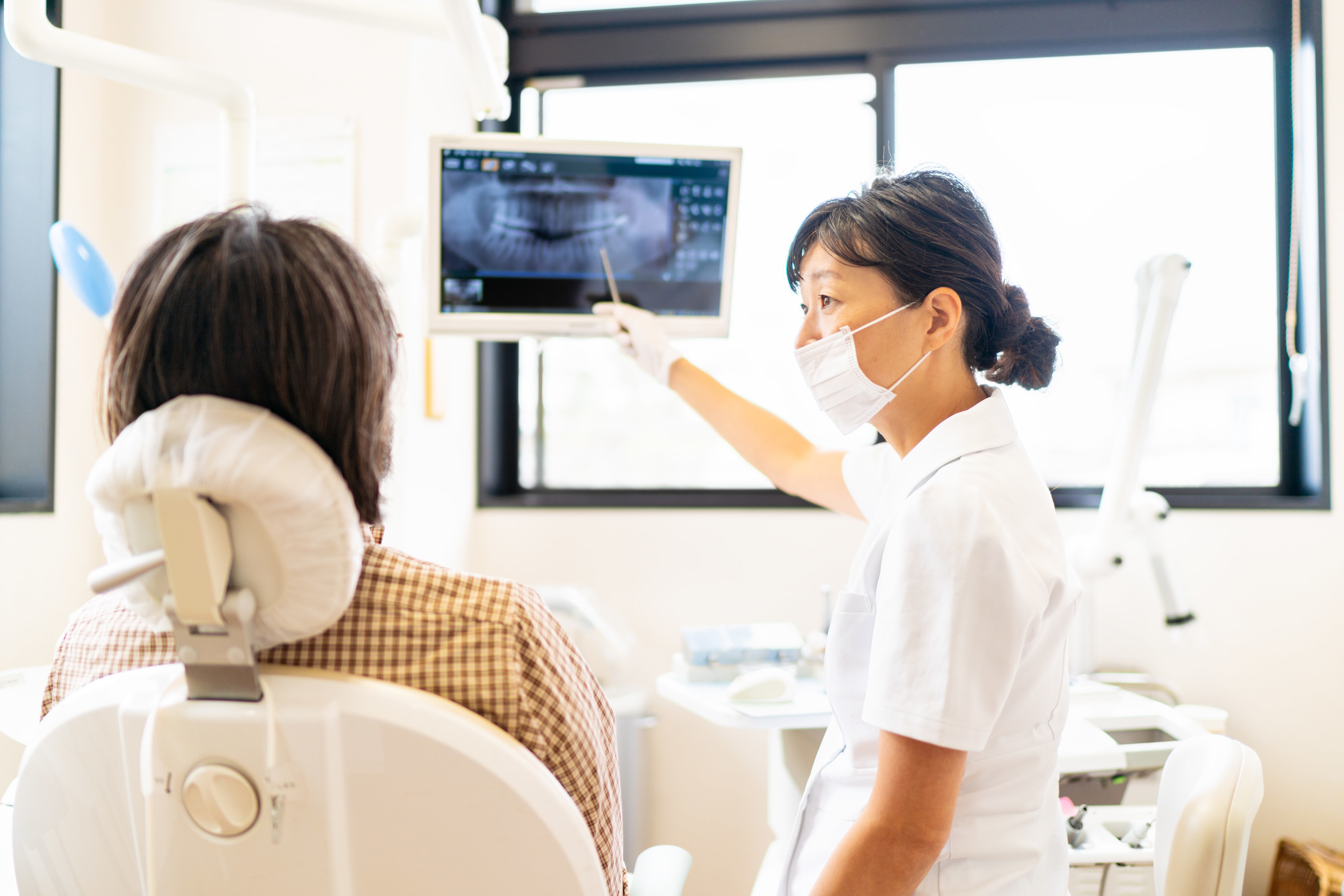 Dentist showing x-rays to a patient