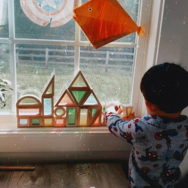 Reviewer's photo of the blocks against a window as a child plays with them