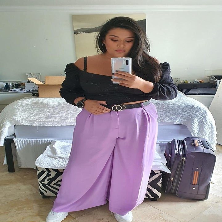 Reviewer wearing the pants in lilac with a black belt