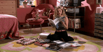 Elle Woods sits in her fashionable dorm reading a book