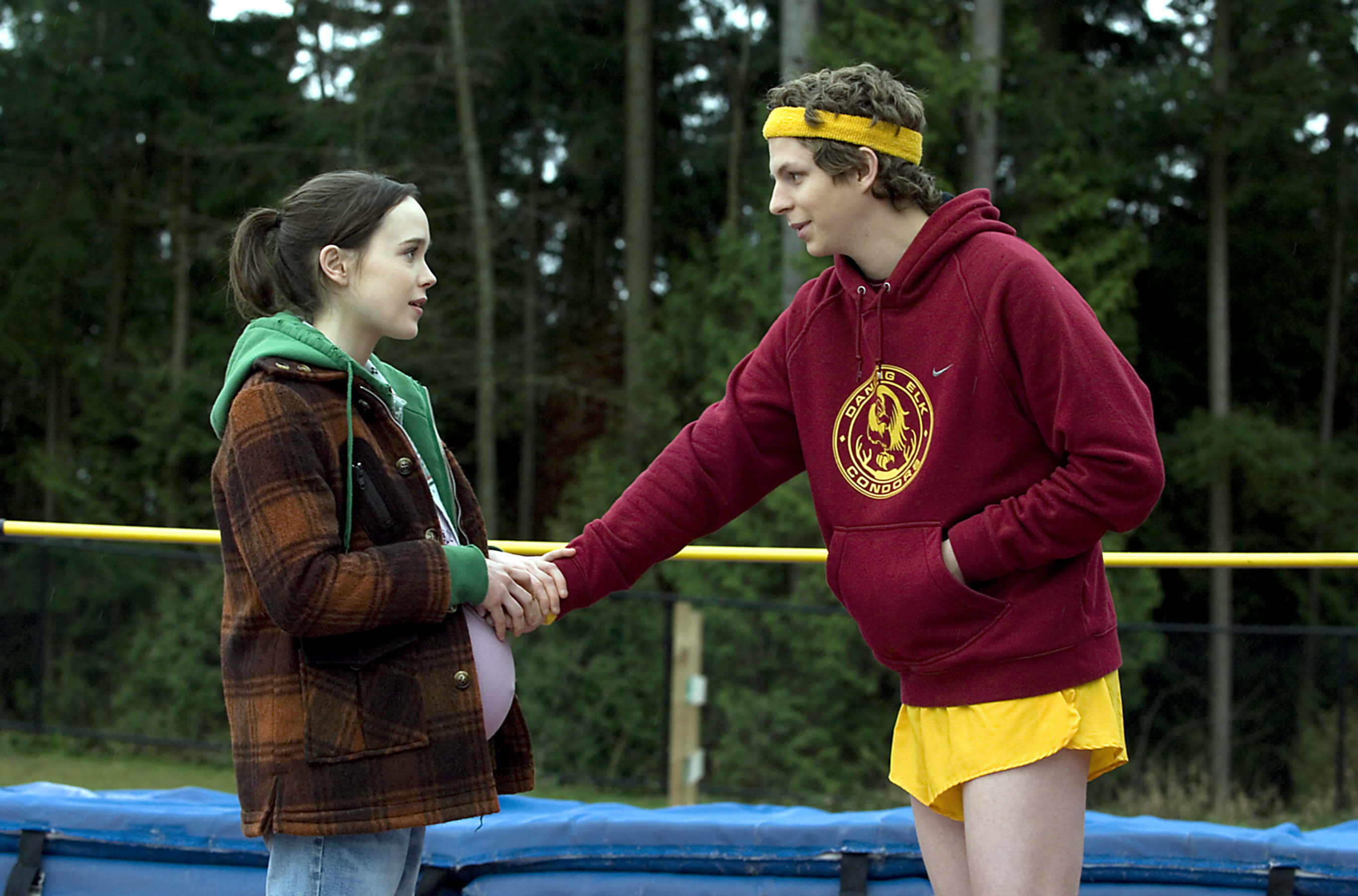 Paulie wearing running shorts, a sweatshirt, and a headband