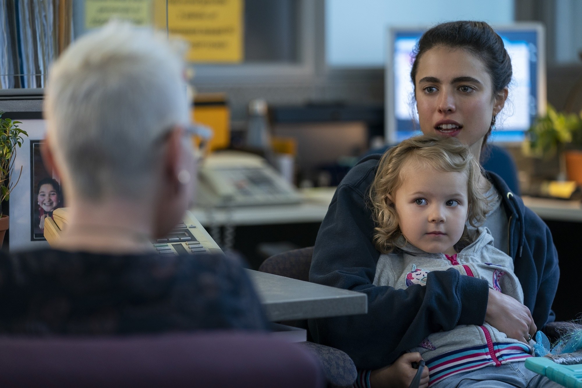 Alex holds Maddy while in the social security office in Netflix series &quot;Maid&quot;