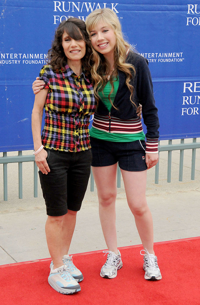 Jeanette with her arm around her mom at a red carpet event