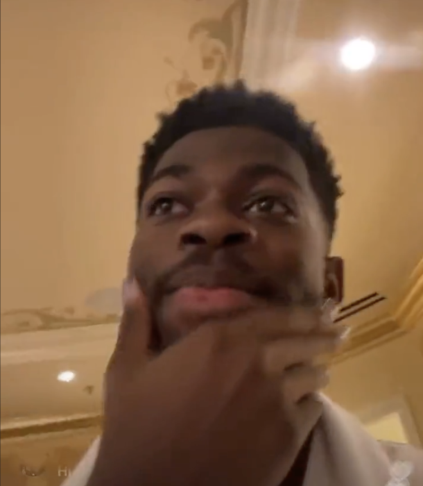Lil Nas with his chin in his hand