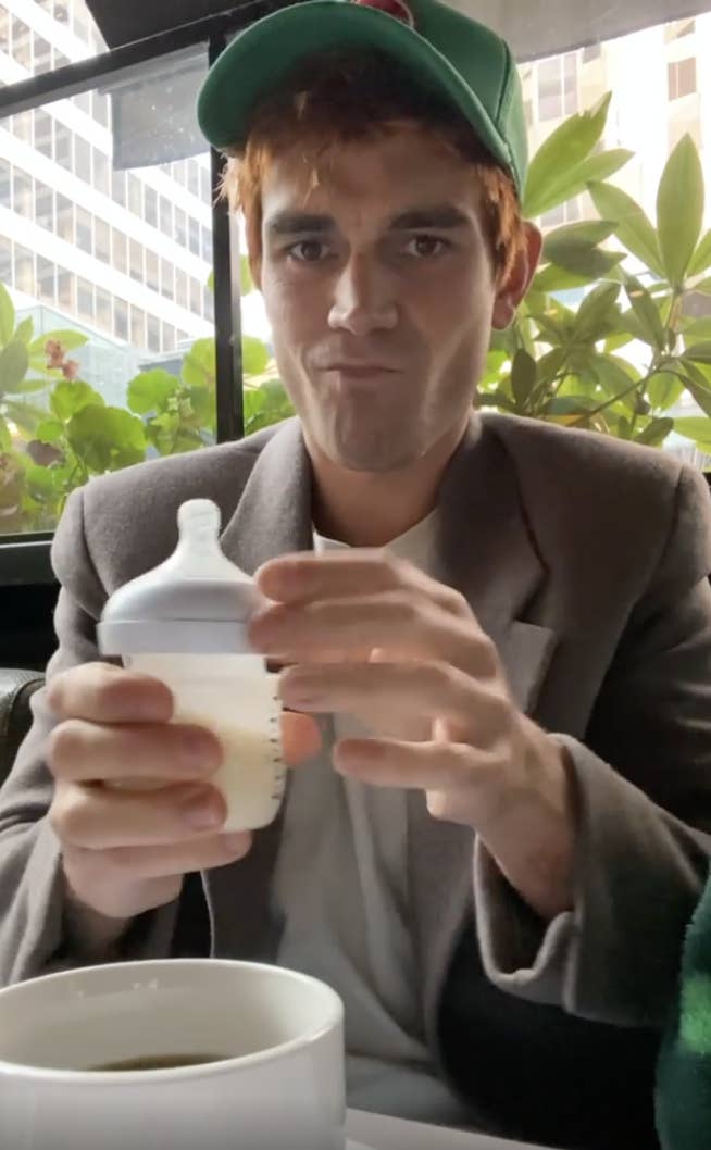 KJ holding a small bottle of breast milk
