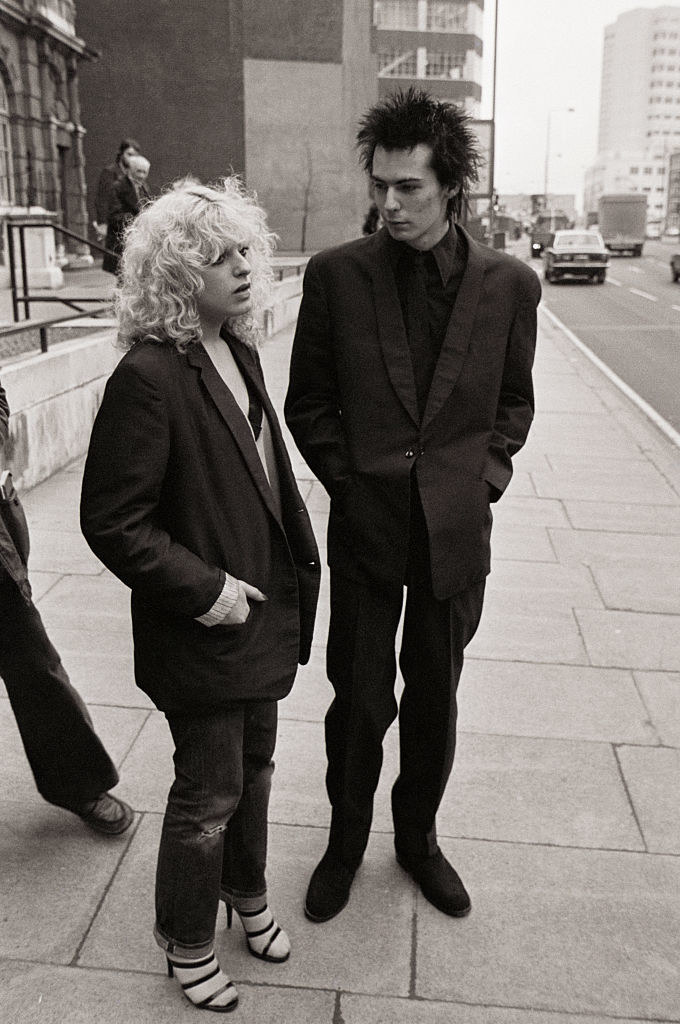 Black-and-white photo of Nancy and Sid standing together on a sidewalk