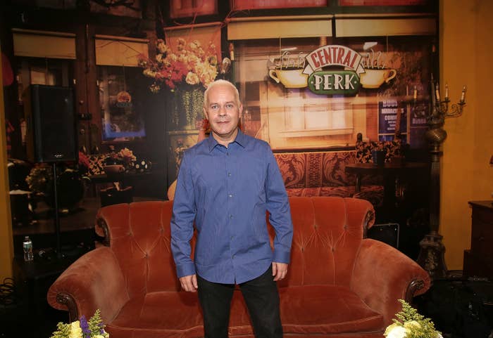James Michael Tyler standing in front of a sofa