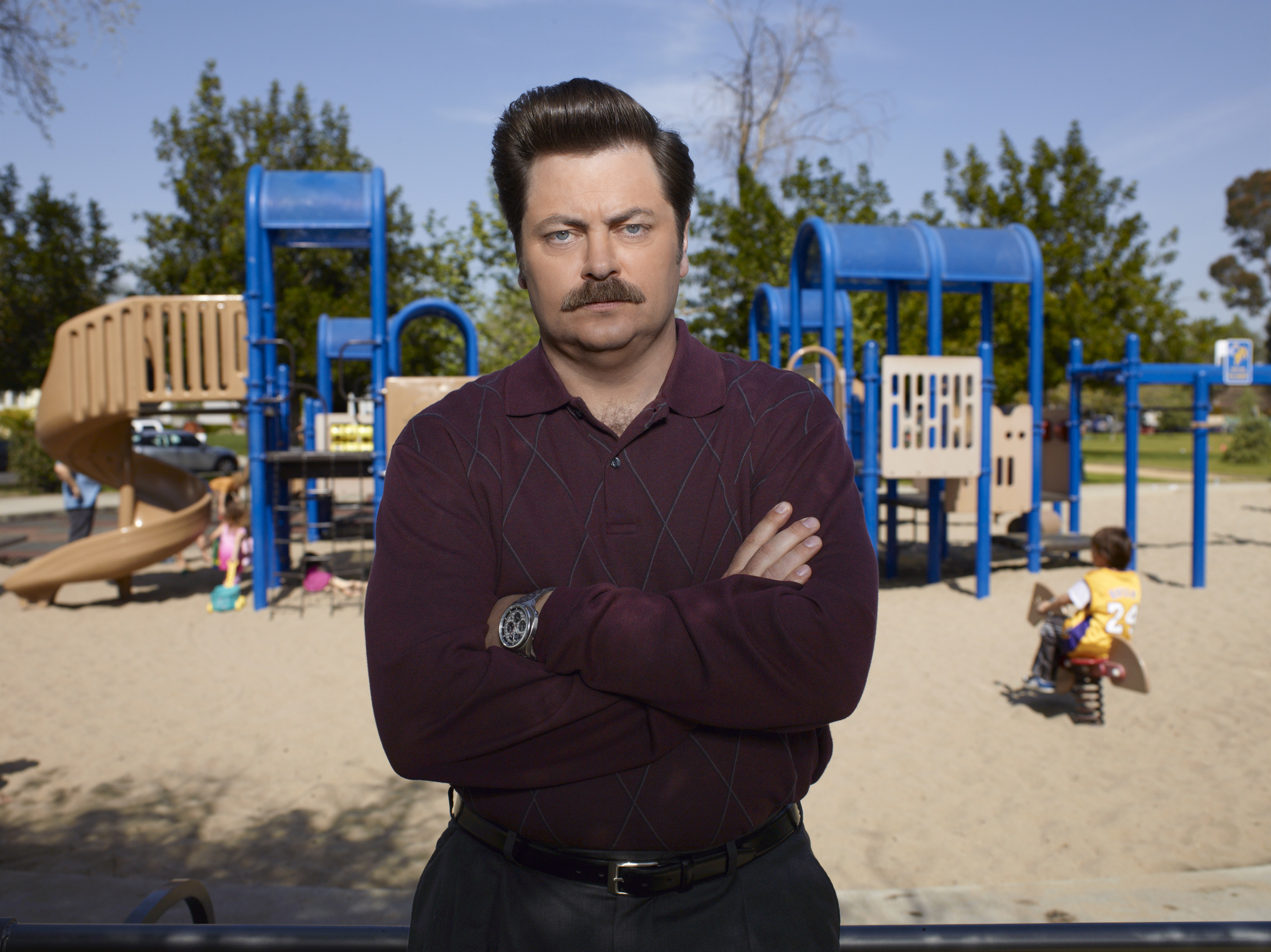 Ron Swanson from &quot;Parks and Recreation&quot; standing in front of a playground