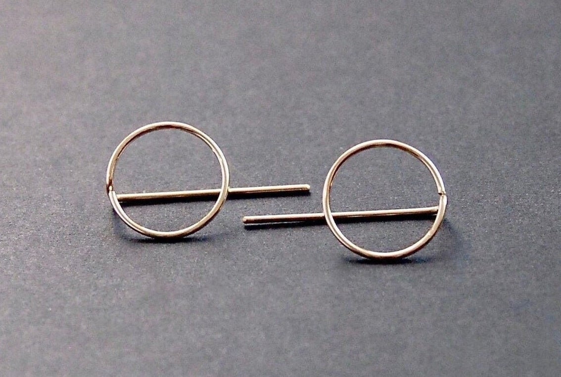 A pair of circular golden earrings