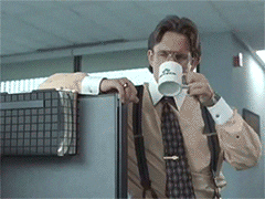 Man in tie drinks coffee in the office