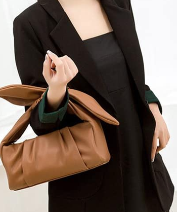 person holding dumpling bag in brown