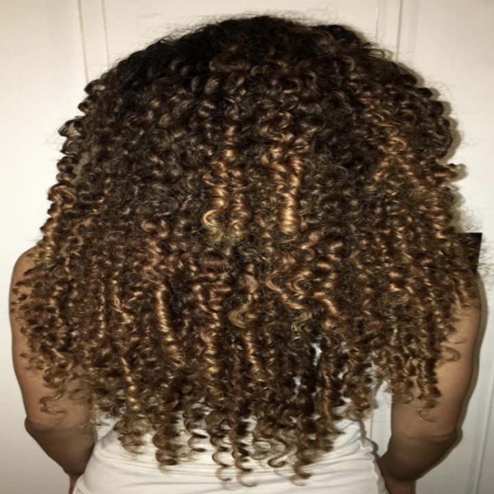 reviewer with long curls down their back. all curls look defined after using product.