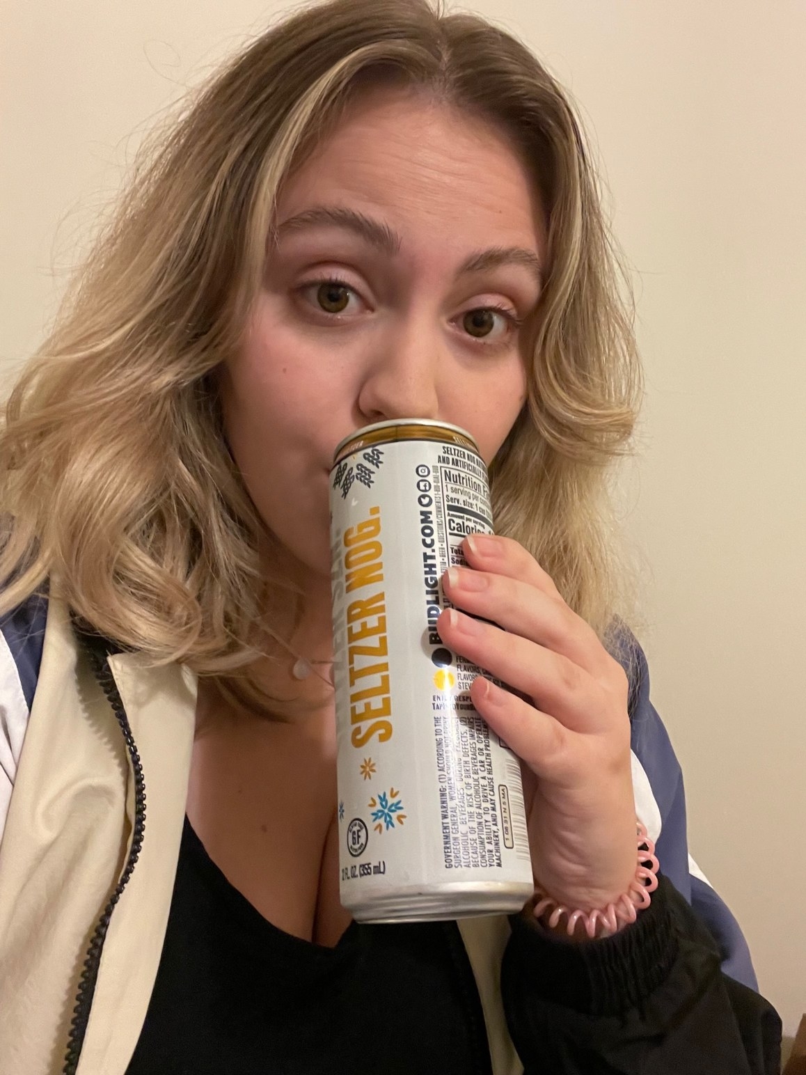 woman sipping a seltzer nog