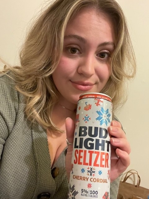 woman holding a cherry cordial seltzer